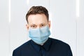 Unhappy, sad young man wearing a protective face mask prevent virus infection or pollution Royalty Free Stock Photo