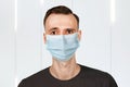 Unhappy, sad young man wearing a protective face mask prevent virus infection or pollution Royalty Free Stock Photo