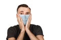 Unhappy, sad young man wearing a protective face mask prevent virus infection or pollution on white isolated background Royalty Free Stock Photo