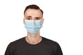 Unhappy, sad young man wearing a protective face mask prevent virus infection or pollution on white isolated background Royalty Free Stock Photo