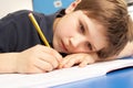 Unhappy Schoolboy Studying In Classroom