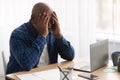 Unhappy Senior Black Businessman Covering Face Sitting Near Laptop Indoor Royalty Free Stock Photo