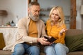 Unhappy Senior Couple Looking At Empty Wallet Sitting At Home Royalty Free Stock Photo