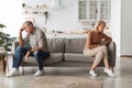 Unhappy Senior Couple Not Speaking After Quarrel Sitting Back-To-Back Indoor Royalty Free Stock Photo