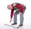 Unhappy senior man with a cane suffering from pain in back or reins over white background Royalty Free Stock Photo