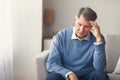 Unhappy Senior Man Thinking About Retirement Sitting On Sofa Royalty Free Stock Photo