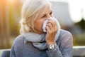 Weeping old woman wipes her eyes with tissue