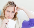 Unhappy sick woman holding tissues