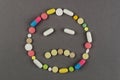 Unhappy smile created from colored pills. Medical concept Royalty Free Stock Photo