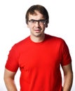 Unhappy squeamish unshaved adult man in red t-shirt and glasses looks at camera trying to see understand something Royalty Free Stock Photo