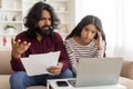 Unhappy, stressed and upset couple paying bills or debt online Royalty Free Stock Photo