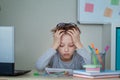 Unhappy and strssed school boy studying with a notebooks on his desk at home. Child is tired of online learning Royalty Free Stock Photo