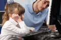 Unhappy teacher and girl using computer in class Royalty Free Stock Photo