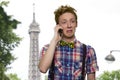 Unhappy teen boy talking on cell phone outdoor. Royalty Free Stock Photo