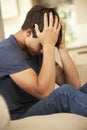 Unhappy Teenage Boy Sitting On Sofa At Home Royalty Free Stock Photo