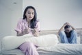 Unhappy teenage couple with pregnancy test on bed Royalty Free Stock Photo