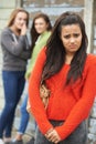 Unhappy Teenage Girl Being Gossiped About By Peers