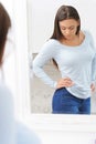 Unhappy Teenage Girl Looking At Reflection In Mirror Royalty Free Stock Photo