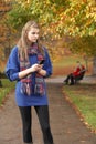 Unhappy Teenage Girl Standing In Autumn Park Royalty Free Stock Photo