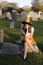 Unhappy Teenage Halloween Witch in Graveyard Royalty Free Stock Photo