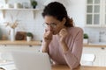 Unhappy thoughtful woman in glasses looking at laptop screen