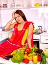 Unhappy tired woman at kitchen