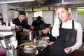 Unhappy waitress waiting dishes in kitchen Royalty Free Stock Photo