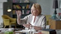 Unhappy troubled elderly woman incredulously looks at a pill. don't want to take medical drugs