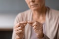 Unhappy unrecognizable senior widow woman holding wedding ring indoors, cropped Royalty Free Stock Photo