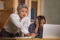 Upset business woman nagging and scolding on employee girl angry for computer mistake in office boss or chief authority and Royalty Free Stock Photo