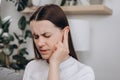 Unhappy upset young caucasian female 25s have ear pain or earache, sad woman suffering painful otitis from loud or noisy sound, Royalty Free Stock Photo