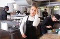 Unhappy waitress waiting dishes in kitchen Royalty Free Stock Photo