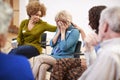 Unhappy Woman Attending Self Help Therapy Group Meeting In Community Center