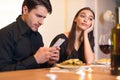 Unhappy Woman Bored On Date, Man Using Phone Royalty Free Stock Photo