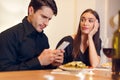 Unhappy Woman Bored On Date, Man Using Phone Royalty Free Stock Photo