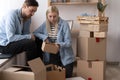 Unhappy woman client dissatisfied by parcel, looking in open cardboard damaged box, crushed fragile goods, bad delivery Royalty Free Stock Photo