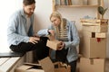 Unhappy woman client dissatisfied by parcel, looking in open cardboard damaged box, crushed fragile goods, bad delivery Royalty Free Stock Photo