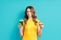 Unhappy woman on dieting looking to smoothie choosing between detox juice and sweets Royalty Free Stock Photo