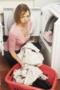 Unhappy Woman Doing Laundry Royalty Free Stock Photo