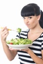 Unhappy Woman Eating a Large Bowl of Green Salad Leaves Royalty Free Stock Photo