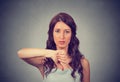Unhappy woman giving thumbs down gesture looking with negative expression and disapproval Royalty Free Stock Photo