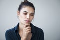 Unhappy woman on gray background