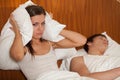 Unhappy woman and her snoring husband. Royalty Free Stock Photo