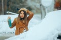 Unhappy Woman Holding Deicing Spray and an Ice Scraper Royalty Free Stock Photo