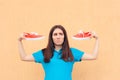 Unhappy Woman Holding a Pair of Red Sport Shoes Royalty Free Stock Photo