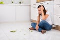 Unhappy Woman Looking At The Broken Plate On Floor Royalty Free Stock Photo