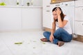 Unhappy Woman Looking At The Broken Plate On Floor