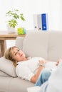 Unhappy woman lying on couch and talking to therapist Royalty Free Stock Photo