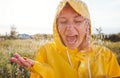 Unhappy Woman In Rain Wearing Waterproof Coat At Outdoor Music Festival