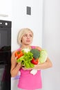 Unhappy woman raw fresh vegetables refrigerator